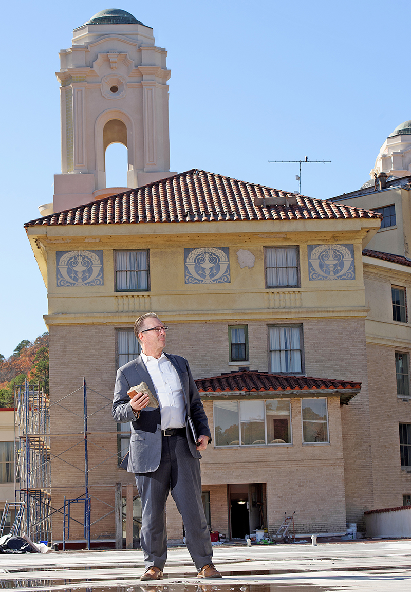 Sky Capital Group’s Scott Larsen holds a piece of damaged masonry removed during the extensive restoration of the Arlington Hotel.