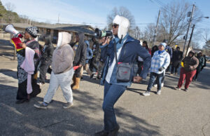 Sylvia C. Brown, in blue with megaphone, marched at a King Day eventin Hope. A social impact advocate and public policy strategist, she believes a Community Reinvestment Act update would benefit many Arkansans. [Steve lewis]