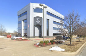 Slim Chickens bought this 35,700-SF, four-story office building in Fayetteville in 2023. [Google Maps]