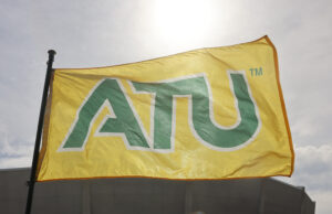 A yellow flag on a flagpost states ATU in green block font