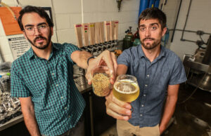 UA grad student Bernardo Guimaraes and assistant professor Scott Lafontaine use malted rice to make gluten-free beer. [Michael Woods]