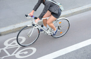Cyclist riding road bike on urban street in athletic gear