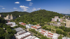 A drone shot of downtown Hot Springs, featuring Bath House row, a row of bohemian-style buildings on a busy street.