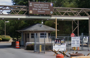 An entrance to the Pine Bluff Arsenal in Arkansas with gates and a guard shack