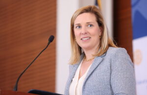 Eliza Hussman Gaines, publisher of the Arkansas Democrat-Gazette, stands behind of a podium at a Rotary Club of Little Rock meeting