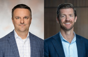 A photo showing Brian Jackson and Jonathan Schneider, each wearing suit jackets and button-down shirts