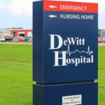 A photo of the DeWitt Hospital sign outside the hospital.