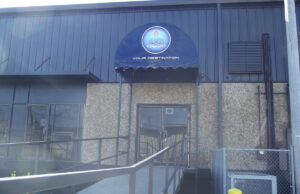 A photo of the front entrance to Triniti Nightclub, a plain doorway on a warehouse building.