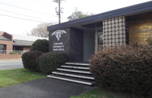 A photo of the Arkansas Cattleman's Association office, a mid-century modern single-story building with a decorative brick facade.
