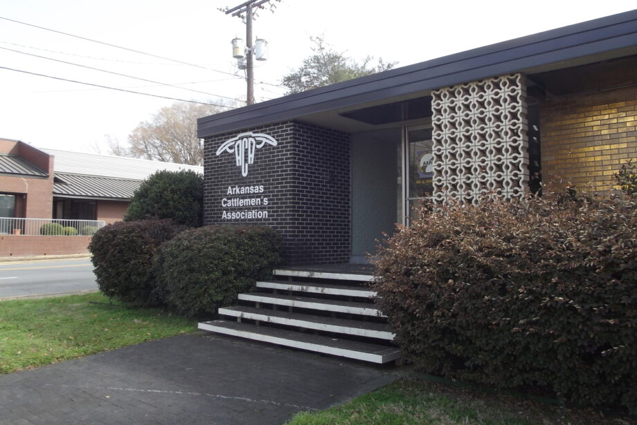 A photo of the Arkansas Cattleman's Association office, a mid-century modern single-story building with a decorative brick facade.