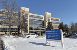 A daytime photo of the Hickingbotham Outpatient Center, a multi-story building with large windows.