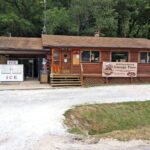The old Buffalo Outdoor Center, a house-shaped building with a log-cabin facade.