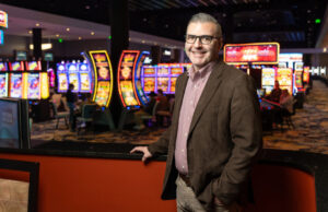 Todd Gold, an older white man, standing on the slot machine floor of Saracen Casino.