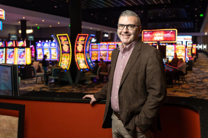 Todd Gold, an older white man, standing on the slot machine floor of Saracen Casino.