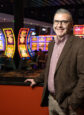 Todd Gold, an older white man, standing on the slot machine floor of Saracen Casino.