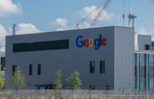 The exterior of a Google data center in the Netherlands, a gray blocky building with "Google" on the side and few windows.